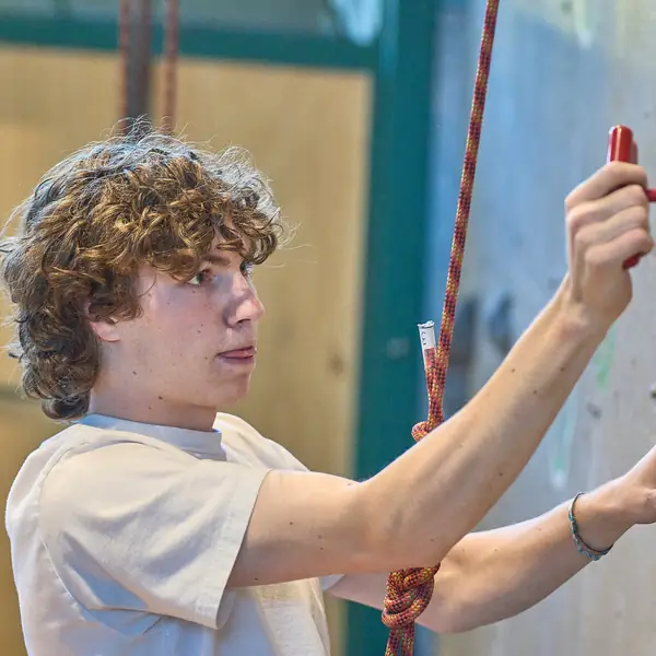 A student on a climbing wall